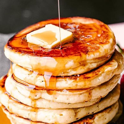 Pancakes impilati e conditi con sciroppo d'acero e burro